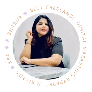 Freelance Digital Marketing Expert in Riyadh:Portrait of a woman sitting at a table, resting her arm and hand on her chin, looking at the camera