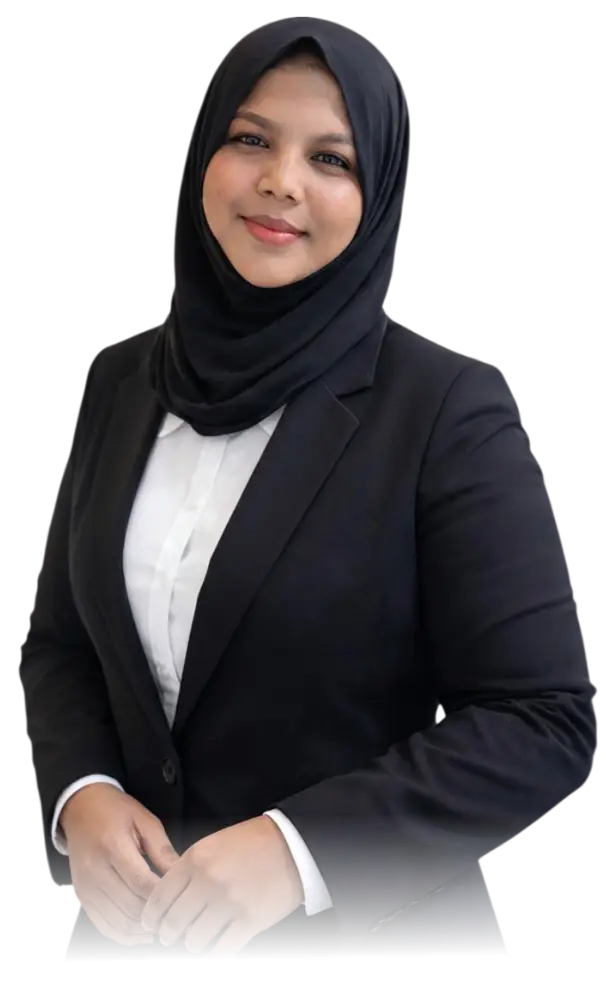 Freelance Digital Marketing Expert in Riyadh: A professional portrait of a woman wearing a black hijab, a white collared shirt, and a tailored black blazer. She is smiling confidently with her hands loosely clasped in front of her against a plain white background.
